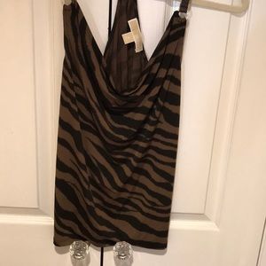 Sexy halter drapes easily for elegant dressing.